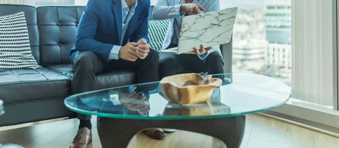 A property valuer and a real estate agent comparing reports