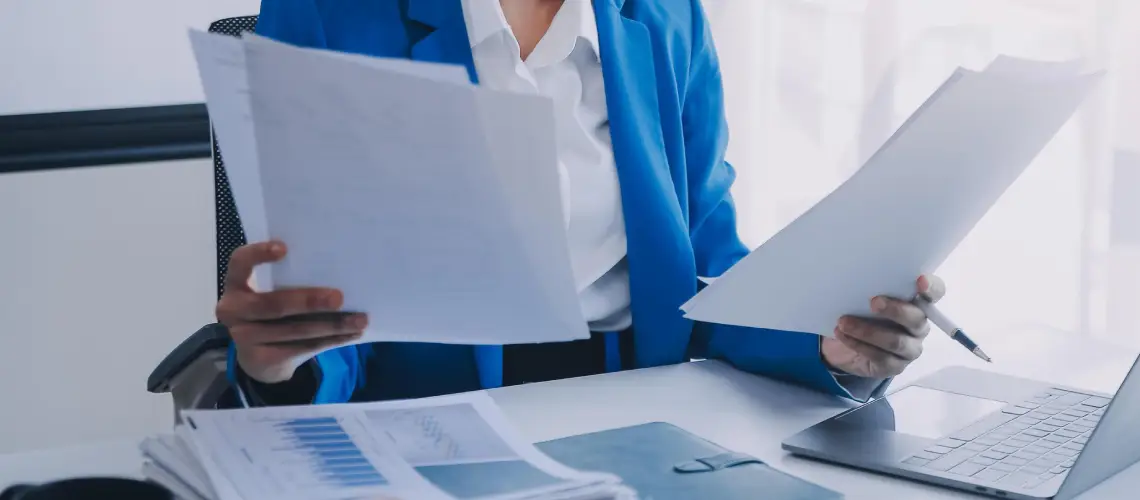 Business consultant analysing documents for business valuation Adelaide in modern office